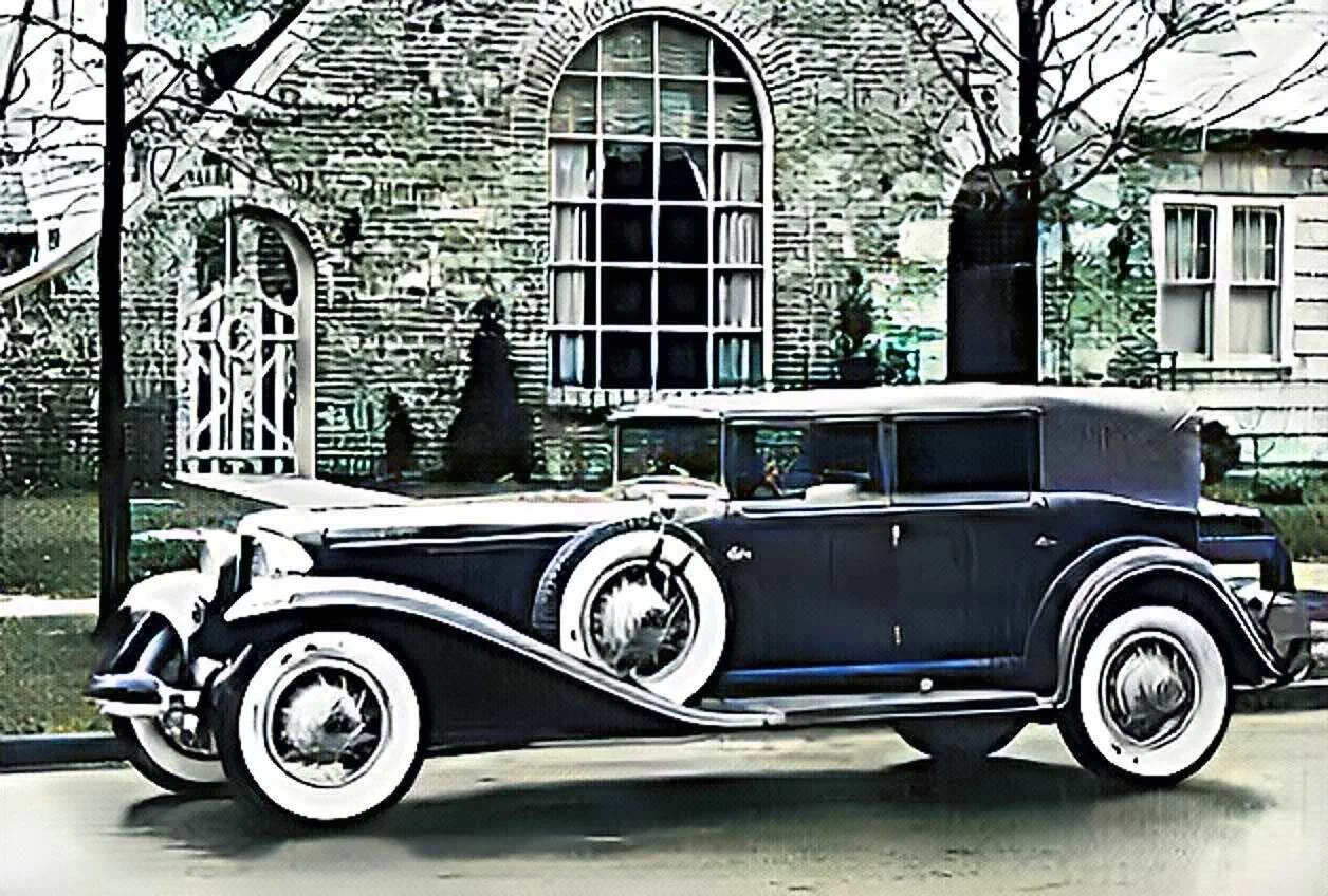 a photo of a 1931 Auburn Cord sitting in front of a house taken from the sales brochure in 1931